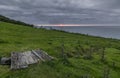 Coastal path wooden bridge, with a cloudy sky and bright sunset