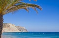 Coastal promenade at Luz beach, Lagos, Portugal. Palm trees and clear blue sky. Royalty Free Stock Photo