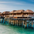 A coastal resort with bungalows built on stilts, offering panoramic views of the ocean3