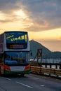 Coastal road and double decker bus in Kennedy Town, Hong Kong Royalty Free Stock Photo