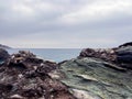 Coastal rock formation with overcast sky and ocean horizon Royalty Free Stock Photo