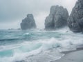 Coastal Rock Formations with Overcast Sky and Ocean Water Crashing. Royalty Free Stock Photo