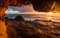 Coastal rock tunnels to cliff ledges with early morning sunlight Royalty Free Stock Photo