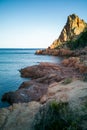 Coastal rocks formed for years by crashing waves. Jagged sea coast lit by first sun rays of day, Sardinia, Italy