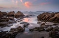 Coastal rocks and reflections in dawn hours Royalty Free Stock Photo