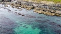 Coastal rocks under sea water, seascape. The coastline of the Atlantic Ocean, the north of Europe. Beautiful ocean water, top view Royalty Free Stock Photo