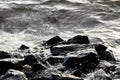 Coastal rocks on wave background