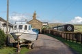 Coastal settlement of West Bay, Dorset, UK - a boat and The Station Kitchen