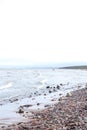 Coastal shore view with baltic sea and rocks on sand Royalty Free Stock Photo