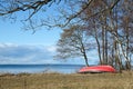 Coastal spring season view with a small rowing boat on land Royalty Free Stock Photo