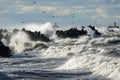 Coastal storm in the Baltic Sea, big waves crash against the harbor breakwater, breaking wave Royalty Free Stock Photo
