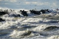 Coastal storm in the Baltic Sea, big waves crash against the harbor breakwater, breaking wave Royalty Free Stock Photo