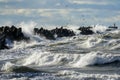 Coastal storm in the Baltic Sea, big waves crash against the harbor breakwater, breaking wave Royalty Free Stock Photo