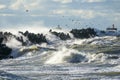 Coastal storm in the Baltic Sea, big waves crash against the harbor breakwater, breaking wave Royalty Free Stock Photo