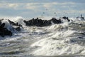 Coastal storm in the Baltic Sea, big waves crash against the harbor breakwater, breaking wave Royalty Free Stock Photo