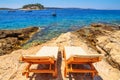 Coastal summer landscape - view of the beach loungers on a rocky seashore, on the island of Hvar
