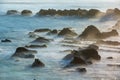 Coastal Sunrise Magic: Sunlight Illuminating the Seaside Rocks.