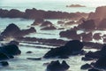 Coastal Sunrise Magic: Sunlight Illuminating the Seaside Rocks.