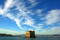 Liguria: coastal tower at sea under a cloudy sky view from the boat Royalty Free Stock Photo