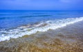 Coastal waves of clear blue sea water. Beach, yellow and white sand in sunny weather, blue sky, summer. Persian Gulf.