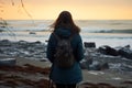 Coastal winter solitude Girl embraces tranquility, standing by the seashore