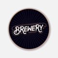 Coaster for beerl with hand written lettering.