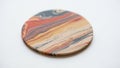 Coaster with a marbled pattern featuring swirls of red yellow blue and Royalty Free Stock Photo