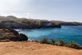 Coastline along Broken Beach, Nusa Penida, Bali. Blue ocean, shoreline cliffs and blue sky in distance. Royalty Free Stock Photo