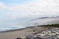 Coastline with beach and mist over the ocean in new zealand