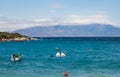 Coastline of beautiful Mediterranean sea with motor boats with thick clouds, Greece