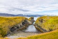 Coastline cliffs with basalt columns at Arnarstapi, scenic and thriving tourism destination in Iceland.