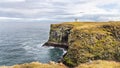 Coastline cliffs with basalt columns at Arnarstapi, scenic and thriving tourism destination in Iceland.