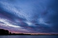 Coastline with cloudy sky in purple sunrise