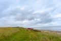 a coastline at the East Sea in Denmark with asmall red boat Royalty Free Stock Photo