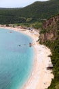 Coastline with Jaz beach in Budva municipality in Montenegro. Parasols with sun beds are on Adriatic sea shore Royalty Free Stock Photo