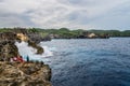 Coastline on Nusa Penida island near Angel`s Billabong beach with tourists