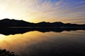 Coastline & reflections along Otago Peninsula lake Royalty Free Stock Photo