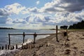 Beach wooden posts clouds Royalty Free Stock Photo
