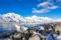 Coastline with stones and cold still waters of antarctic sea lag Royalty Free Stock Photo