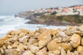 Coastline with stones and surfs in cloudy day Royalty Free Stock Photo