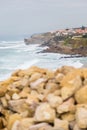 Coastline with stones and surfs in cloudy day Royalty Free Stock Photo