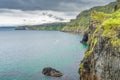 Coastline with tall limestone cliffs and turquoise Atlantic Ocean, near Carrick a Rede rope bridge