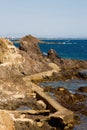 Rocky coasts with an old stone footbridge Royalty Free Stock Photo