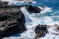 Coastline waves breaking over volcanic rock