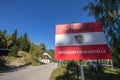 Coat of arms of austria on a roadsign indicating an Austrian Border Crossing, Grenzubergangstelle, at Pavlic pass, at the Austrian