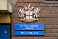 Coat of Arms, City of London School and Staff Entrance signs Royalty Free Stock Photo