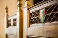 Coat of arms inlaid in some intricate wood carving in a chair ma