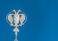 Coat of arms of Russia, silver double-headed eagle against the background of blue sky. Silver Russian heraldic symbol, background