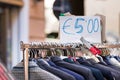 Men suits second hand on a rack for sell at cheap price at a street market in Ancona Italy Royalty Free Stock Photo