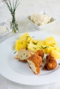 Coated cauliflower cut in half and chive potatoes Royalty Free Stock Photo